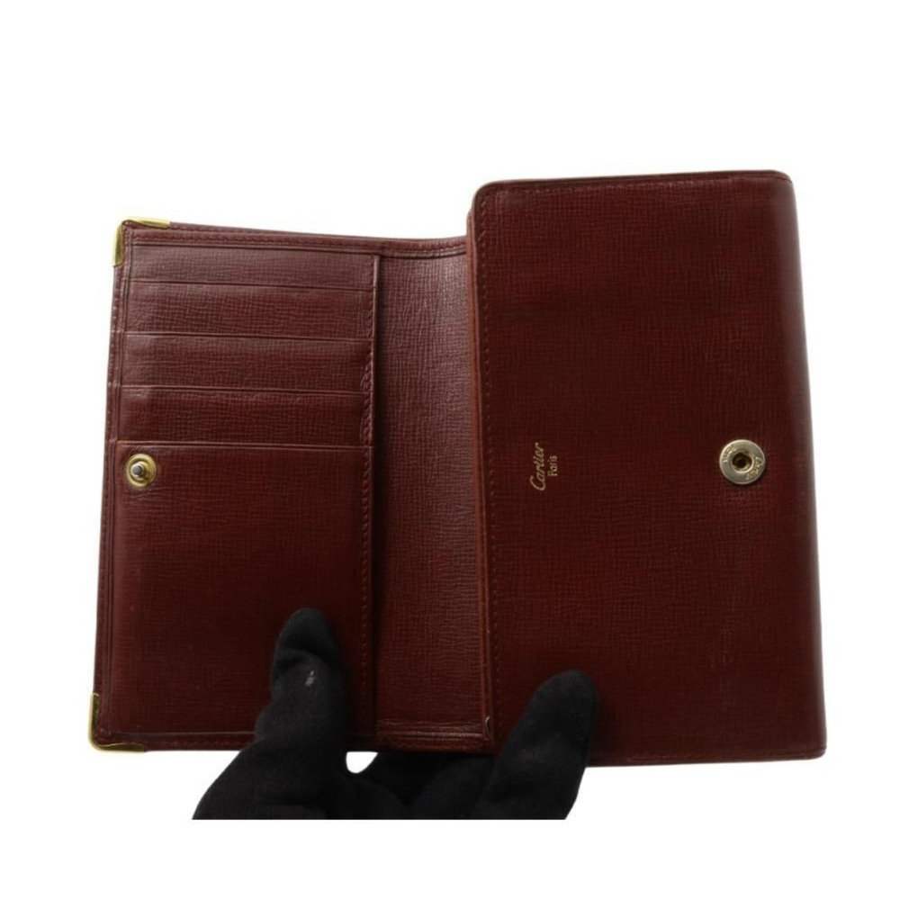 Cartier Burgundy leather long wallet with 24kt coated hardware.